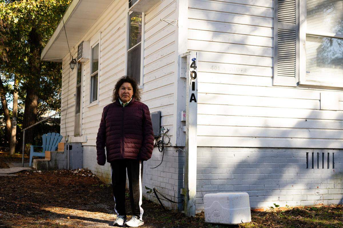 Cheryl Carline outside her home on Alder Street. She wanted to live close to a grocery store, and the short walk would be gentle on her back. The weekly specials at Food Lion also made things affordable, she said. “I was really counting on Food Lion being right there,” said Carline, who walks with a cane and doesn’t have a car.