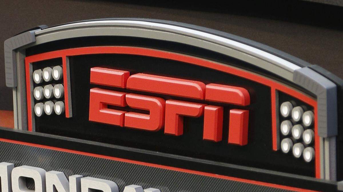 FILE - In this Sept. 16, 2013, file photo, an ESPN logo is seen prior to an NFL football game between the Cincinnati Bengals and the Pittsburgh Steelers in Cincinnati. The network will air the inaugural Overwatch League Grand Finals in prime time this month as part of a multiyear agreement to bring esports to the biggest sports platform on American television. Disney and Blizzard Entertainment announced plans Wednesday, July 11, 2018, to broadcast the OWL’s playoffs and championship on ESPN, ABC and Disney XD. The Grand Finals on July 27 and 28 will be shown live on ESPN, marking the first time the network will carry esports in prime time.