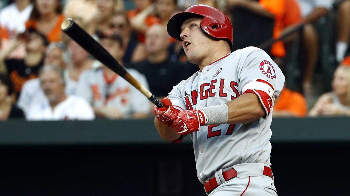 FILE - In this Aug. 19, 2017, file photo, Los Angeles Angels’ Mike Trout watches his solo home run in the first inning of a baseball game against the Baltimore Orioles in Baltimore. A person familiar with the negotiations tells The Associated Press Tuesday, March 19, 2019, that Trout and the Angels are close to finalizing a record $432 million, 12-year contract that would shatter the record for the largest deal in North American sports history. (AP Photo/Patrick Semansky, File)