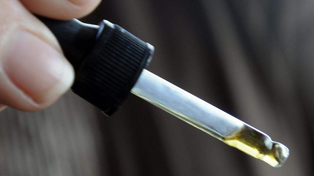 Janel Ralph holds a dropper containing CBD oil, a derivative of marijuana that her 5 year-old daughter, Harmony takes to control her epileptic seizures. 