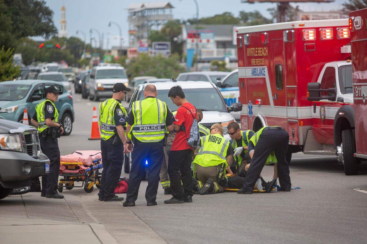Myrtle Beach Fire Rescue and Myrtle Beach police tend to an injured bicyclist hit by a car around 3:15 p.m. at the corner of 5th Ave. N. and Kings Hwy. in Myrtle Beach on Friday.
