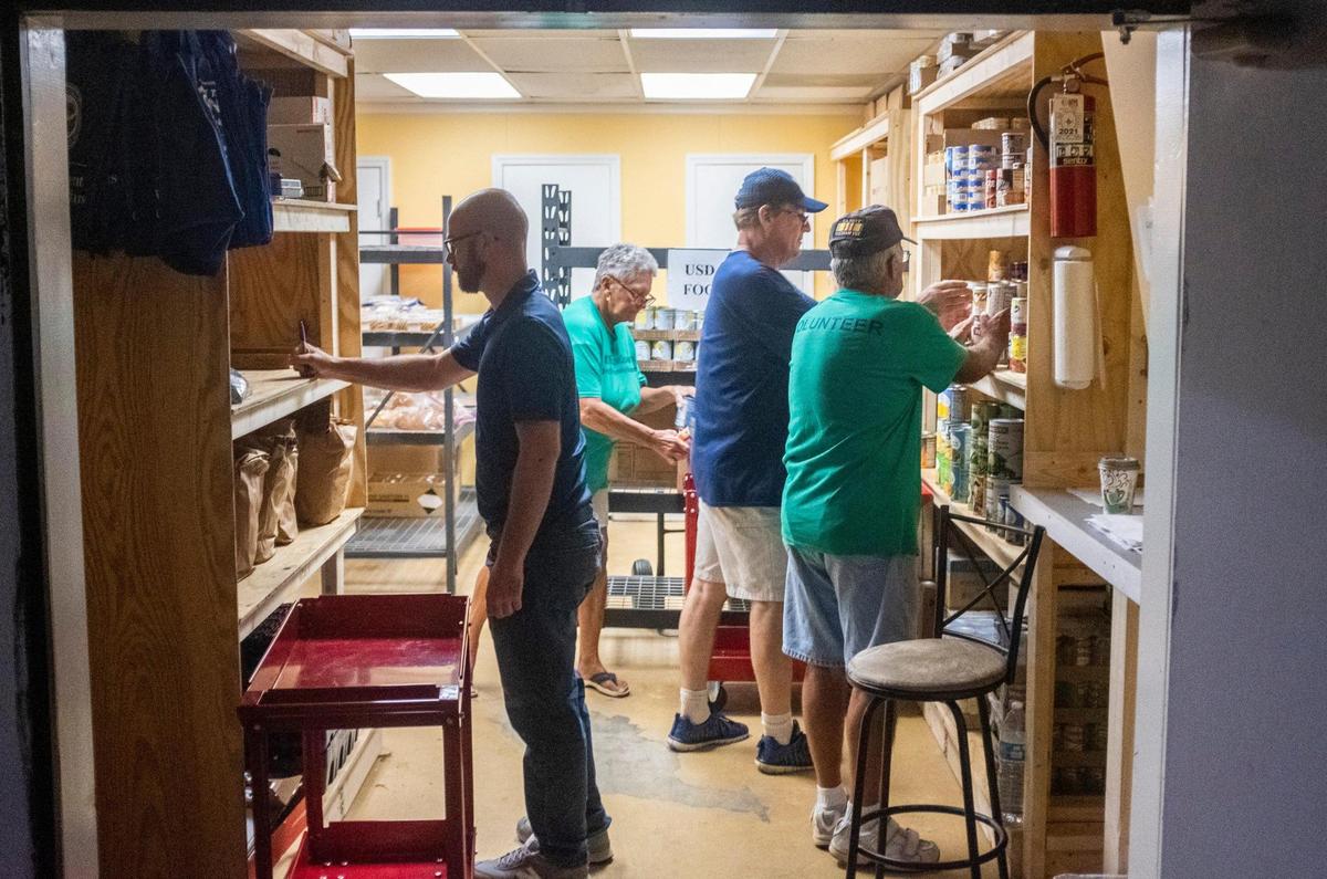 Veterans fill a food order from the shelves of the Socastee Food Pantry. The pantry is a veteran run food source in the Socastee community, a part of Faith Outreach Ministries, which facilitates food distribution events each month in Horry County. June 23, 2021.