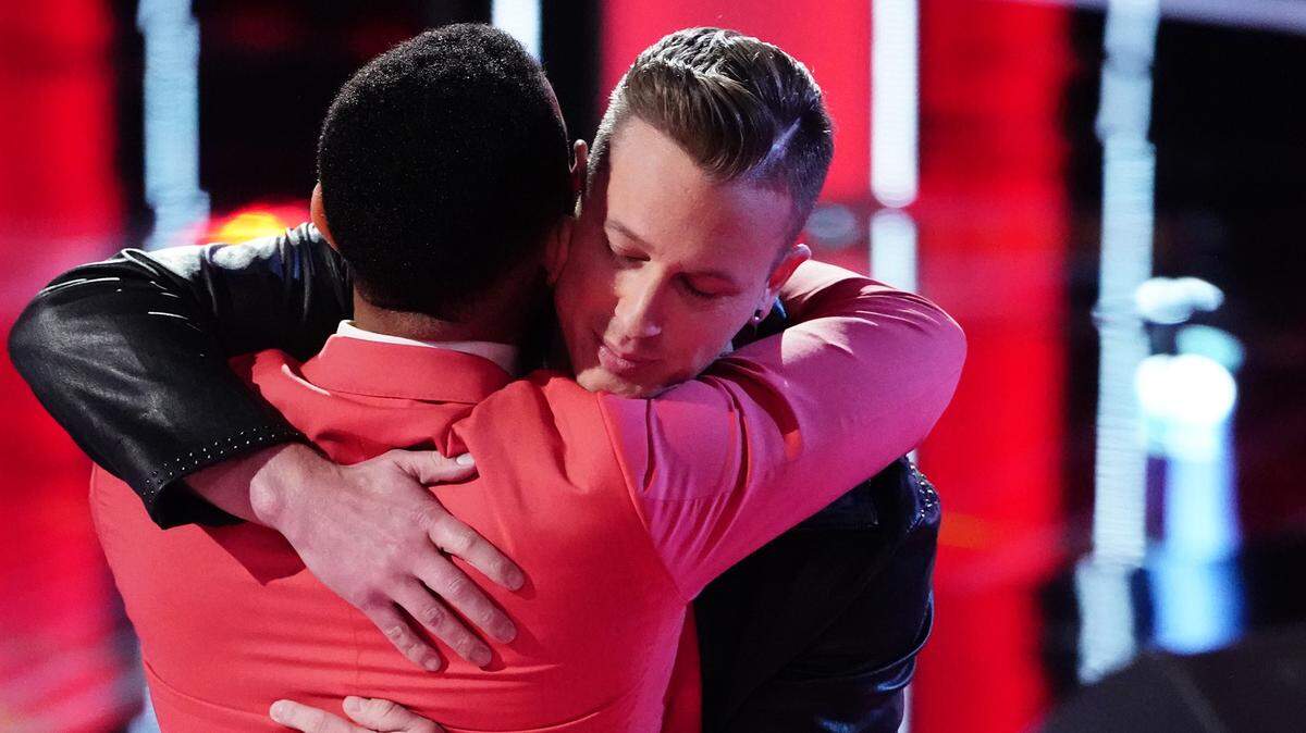 Myrtle Beach resident Jimmy Mowery (facing) hugs “The Voice” coach John Legend during the show’s live cross battles.