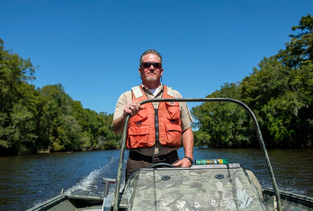 Craig Sasser, manager of the The Waccamaw National Wildlife Refuge, pilots a boat on the Great Pee Dee River. Established in 1997 along the Waccamaw and Pee Dee Rivers, the refuge serves to protect native forest, wetlands and threatened species, as well as to educate the public about the area’s natural resources. Sept. 19, 2019.