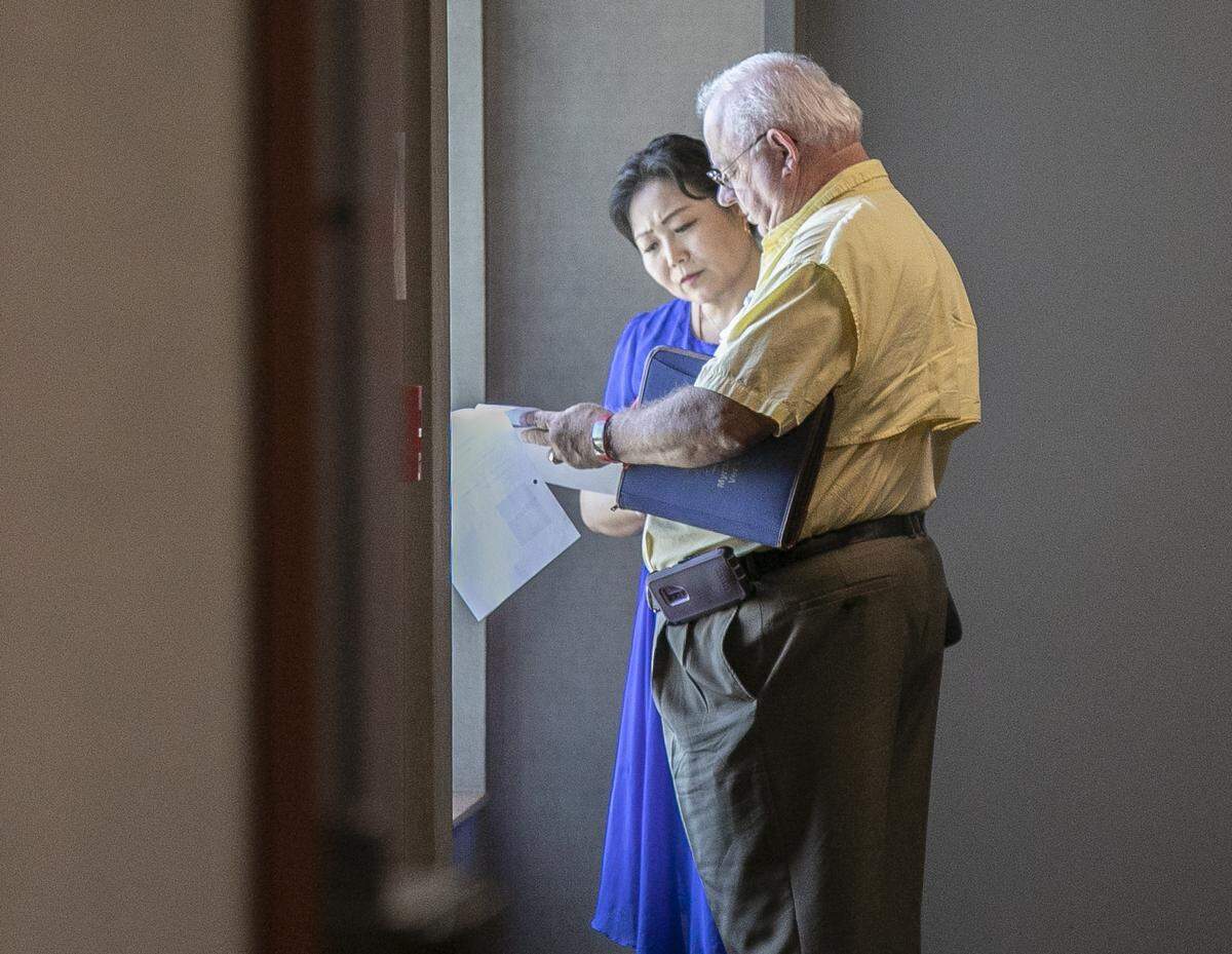 Samuel Owenby and Xuemei Zhang, owner of Yuki Spa Massage in North Myrtle Beach, look over court documents at the Horry County Courthouse on Oct. 01, 2019.