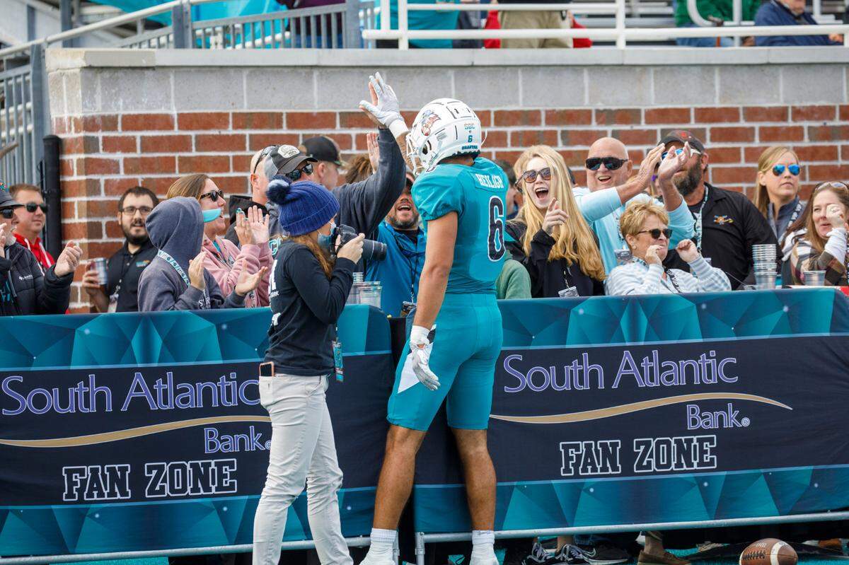 Coastal’s Jaivon Heiligh celebrates touchdown pass with fans on the sideline on Saturday. Coastal Carolina played Texas State in college football. The Coastal Carolina Chanticleers played the Texas State Bobcats in a Sun Belt Conference NCAA FBS college football game in Conway SC. Nov. 20, 2021.