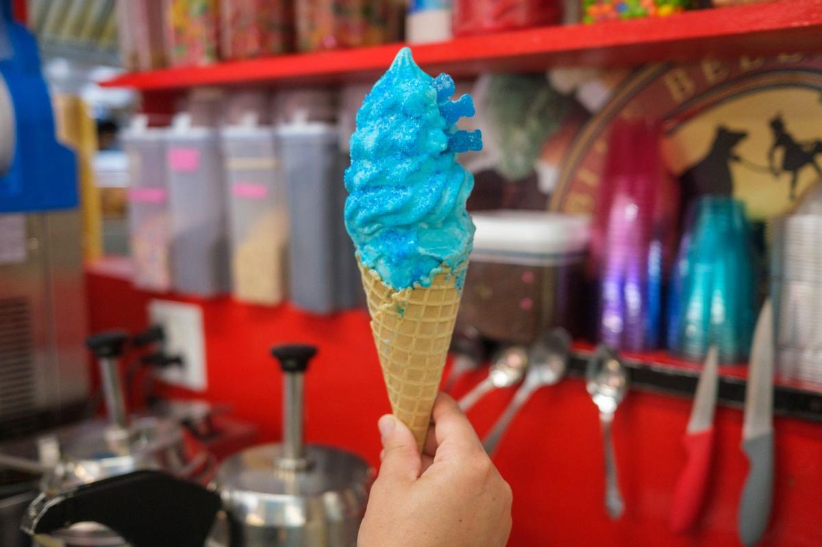 Debbie Serra, owner of Mr. G’s Ice Cream & Grill in North Myrtle Beach makes a “Blue Hawaii” cone. The shop has gone viral on TikTok and other social media for it’s unique dessert creations. June 27, 2024.