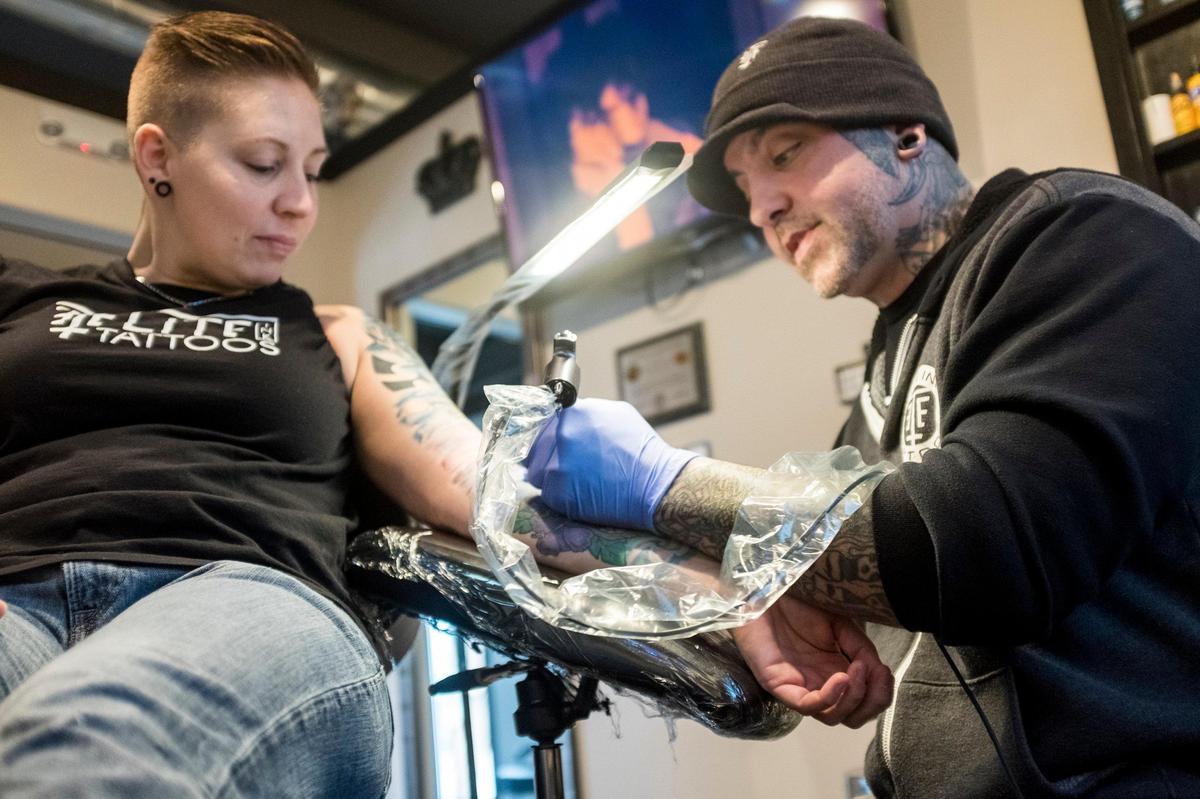 Richard Lanz, co-owner of Elite Ink Tattoos works on a Kassie Hawse’s Hawaiian themed tattoo. Lanz owns one of over a dozen tattoo shops on Seaboard Street and explained that Myrtle Beach city zoning laws regulate shops like his to industrial areas. Dec 10, 2018.