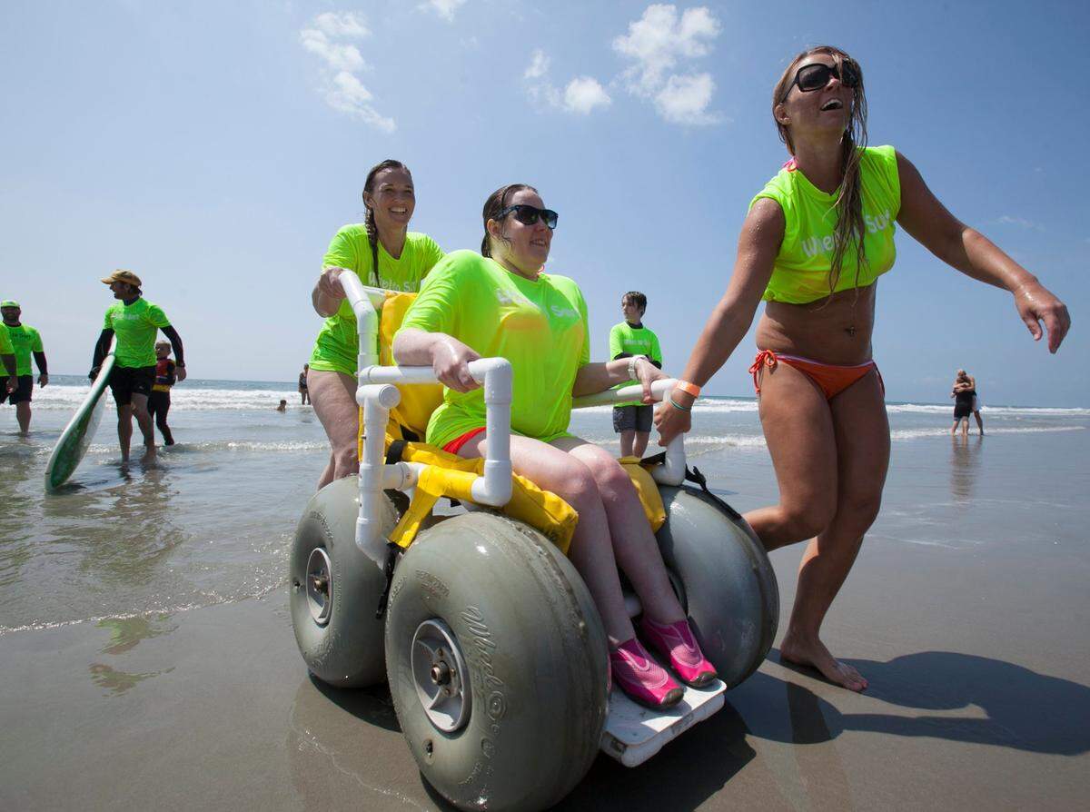 Mary Gainey rides on the beach after a surf session at the “Wheel to Surf” Adaptive Surfing Clinic in North Myrtle Beach. File photo.