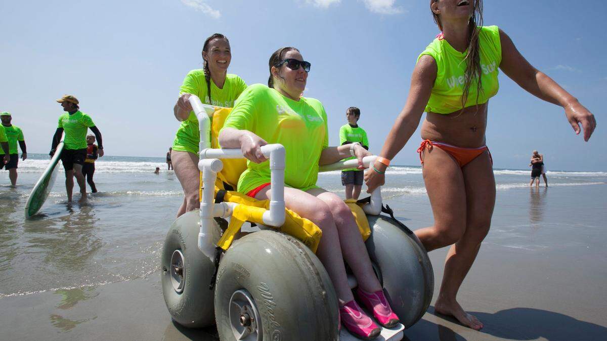 Mary Gainey rides on the beach after a surf session at the “Wheel to Surf” Adaptive Surfing Clinic in North Myrtle Beach. File photo.
