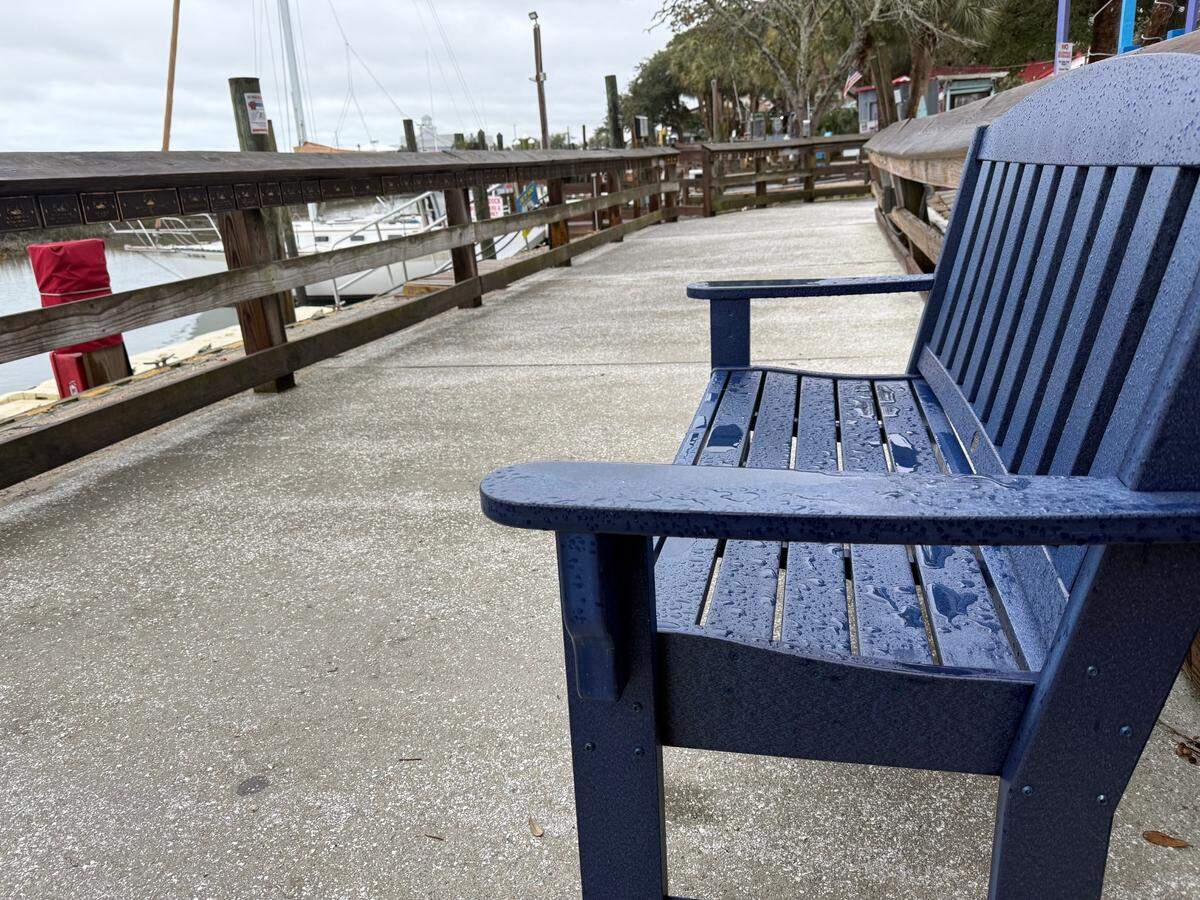 A bench at the Murrells Inlet MarshWalk on Jan. 11, 2025 shows visible signs of the rain that came through the area the night before.