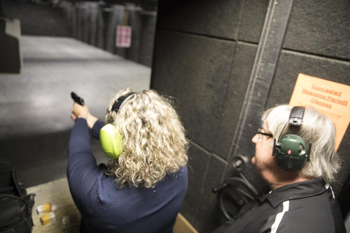 Joe DeFeo, Horry County school board chair, teaches a firearms class to school board member Janice Morreale. DeFeo also helps teaching ballroom dancing on Wednesday nights. DeFeo is a helicopter pilot, state constable, and karaoke D.J. in his spare time.