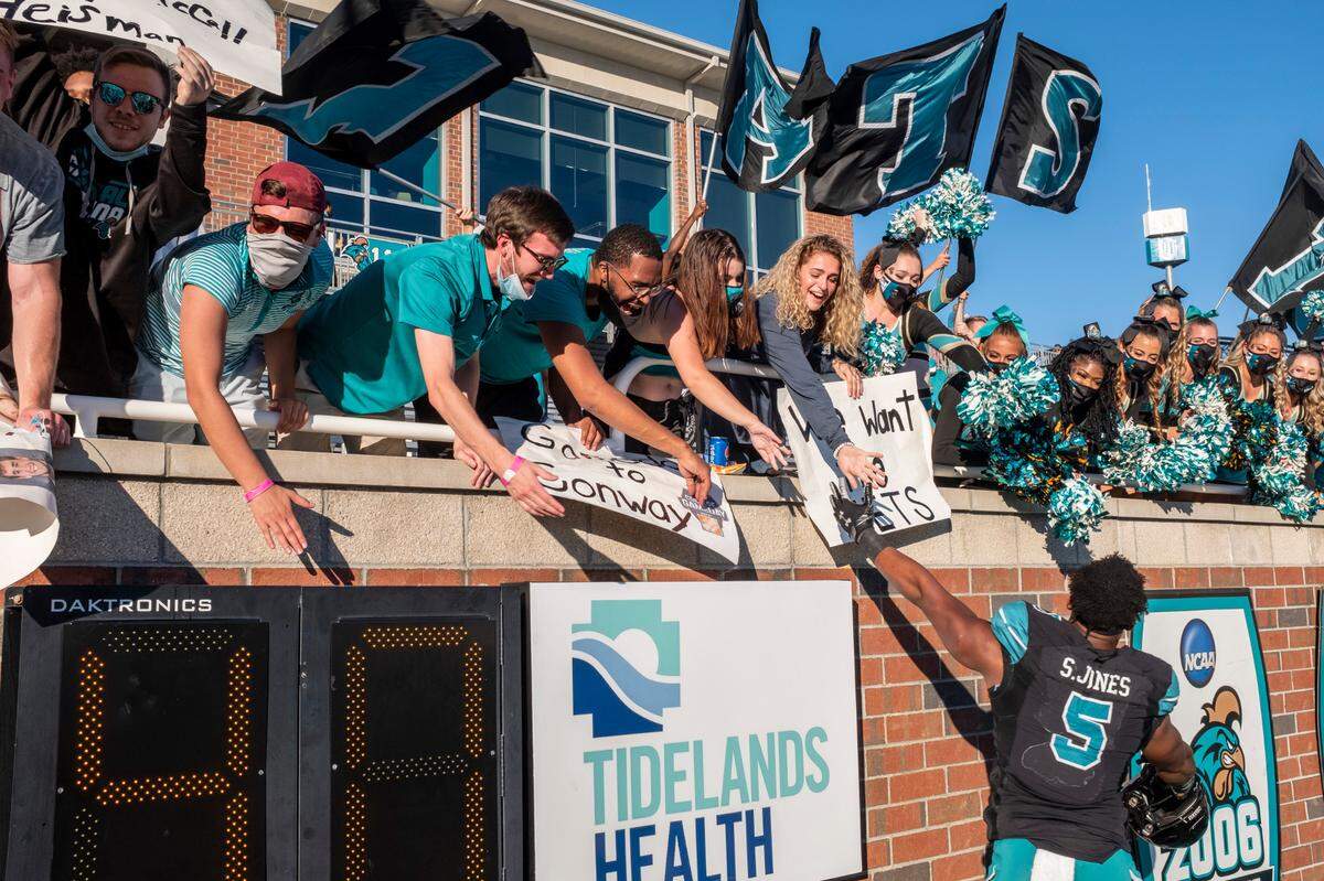 CCU junior running back Shemari Jones celebrates Coastal’s win with fans on Saturday. Coastal Carolina played Appalachian State with first place in the Sun Belt Conference’s East Division on the line at Brooks Stadium in Conway. November 21, 2020.