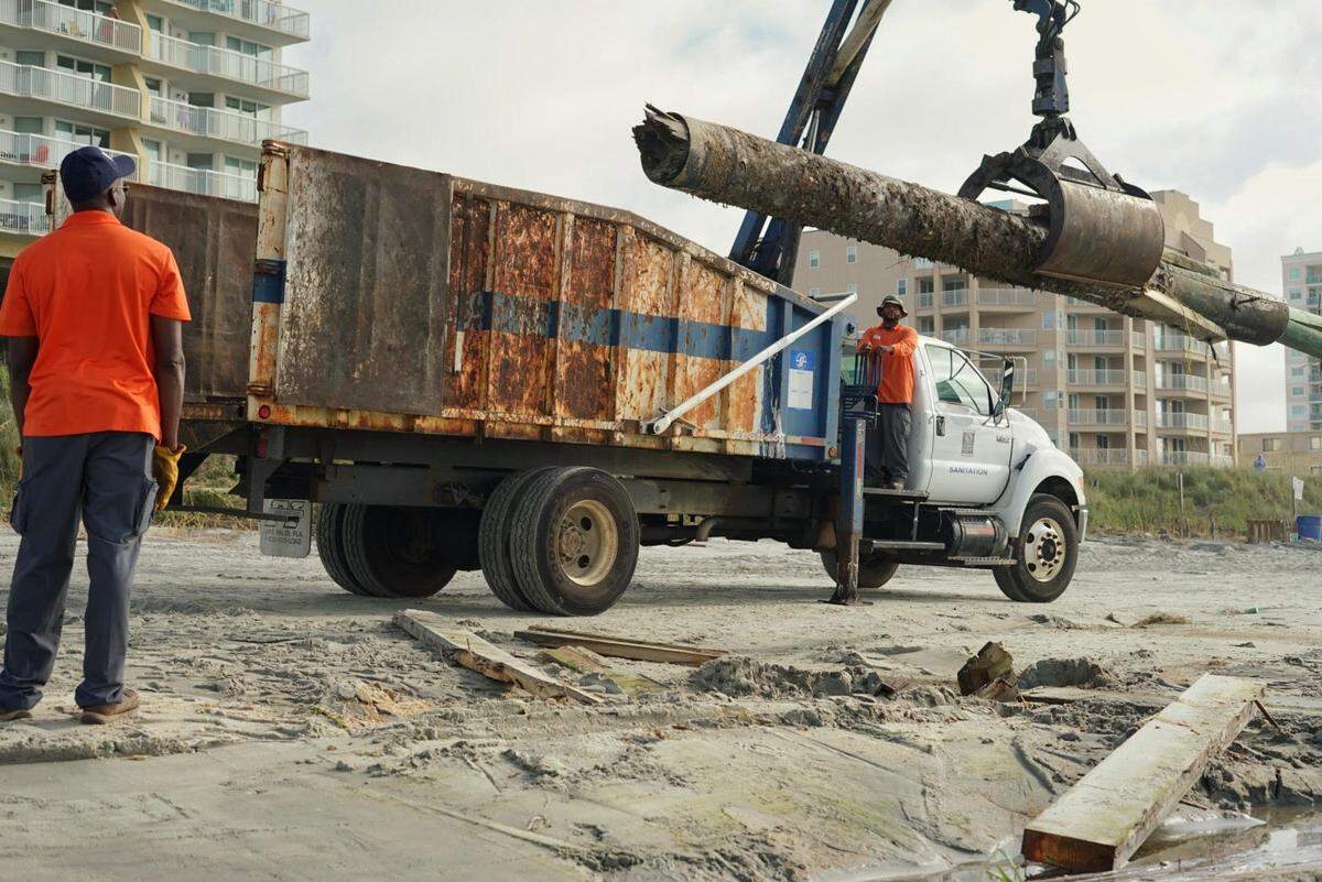 Workers clean up storm damage in Cherry Grove.