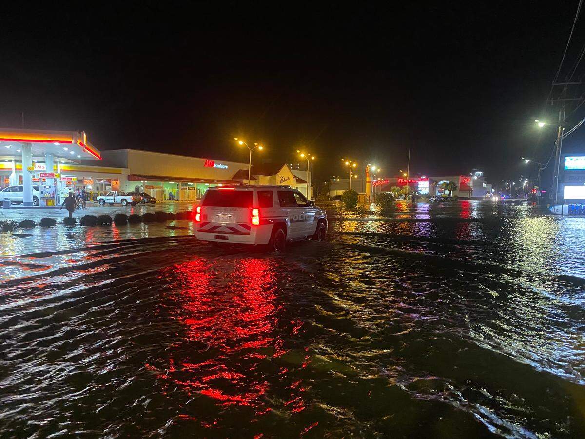 A vehicle drives a flooded Sea Mountain Highway in the Cherry Grove portion of North Myrtle Beach on Monday night. Hurricane Isaias hit the Myrtle Beach area Monday night.