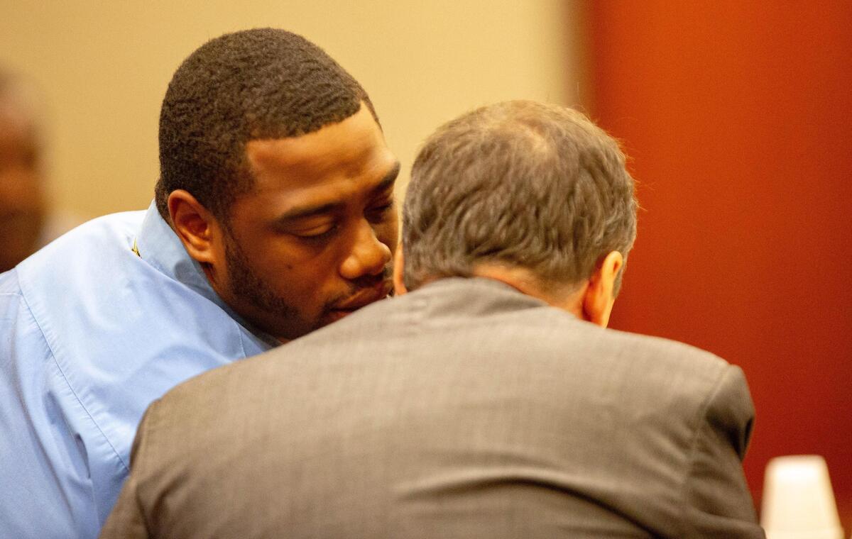 Meleke Stewart whispers to his attorney Wednesday at the Horry County courthouse. Stewart was convicted of murder and other charges Thursday in the shooting death of 34-year-old Alton Daniels in June 2014.
