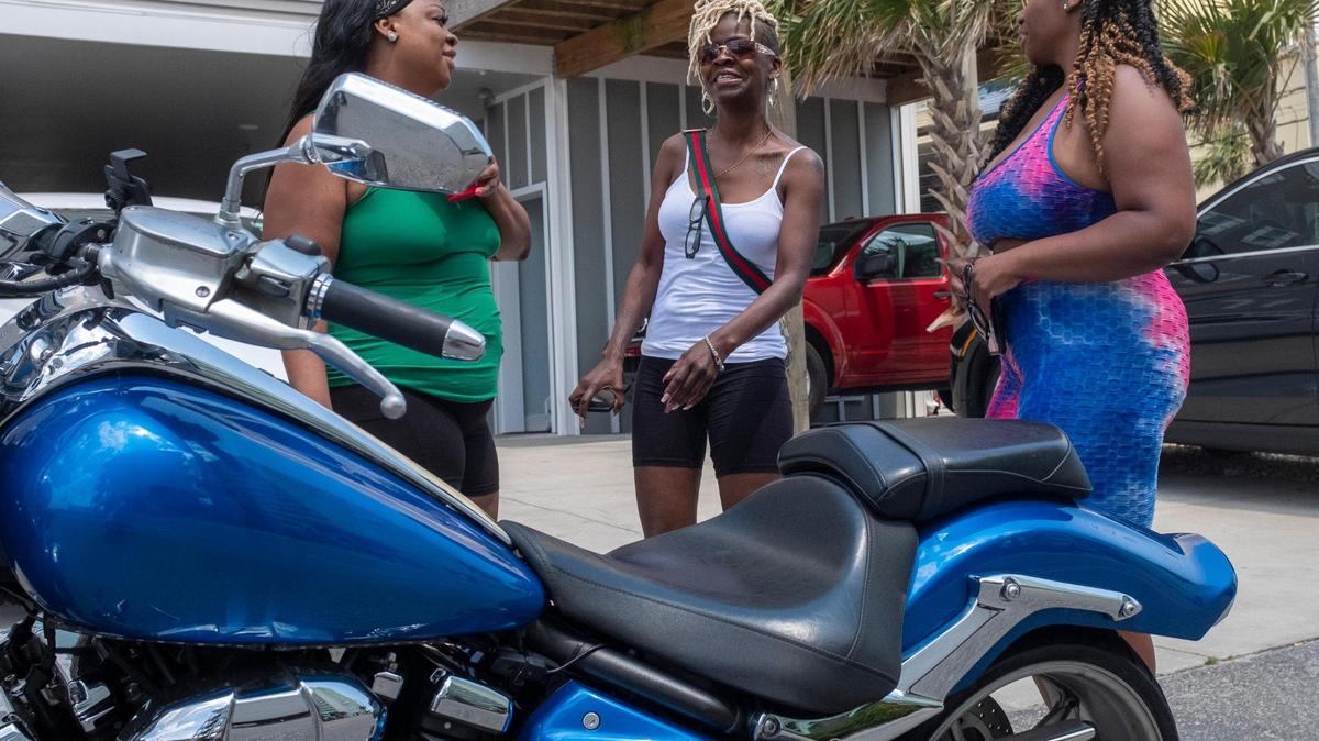 Members of the Black Dragon Kings motorcycle club socialize outside a beach house in North Myrtle Beach on Thursday. Small groups of bikers have arrived on the North end of the Grand Strand for Memorial Day weekend despite Atlantic Beach canceling it’s annual motorcycle festival for the second year due to COVID-19. May 27, 2021.