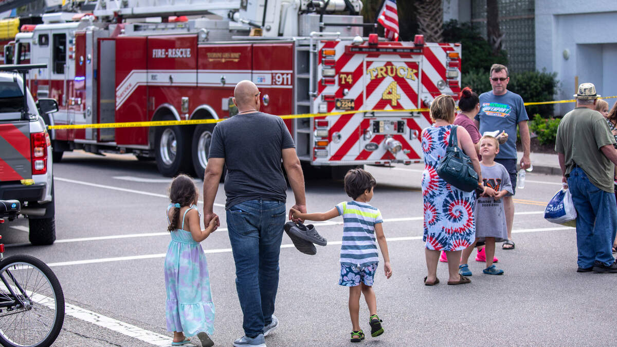 Visitors load buses after being evacuated from Captain Quarter’s Resort a fire on Wednesday morning that resulted in hundreds of visitors evacuated the ocean front resort. There were no injuries reported among guests but at least three firefighters were treated for dehydration. Aug. 16, 2023.