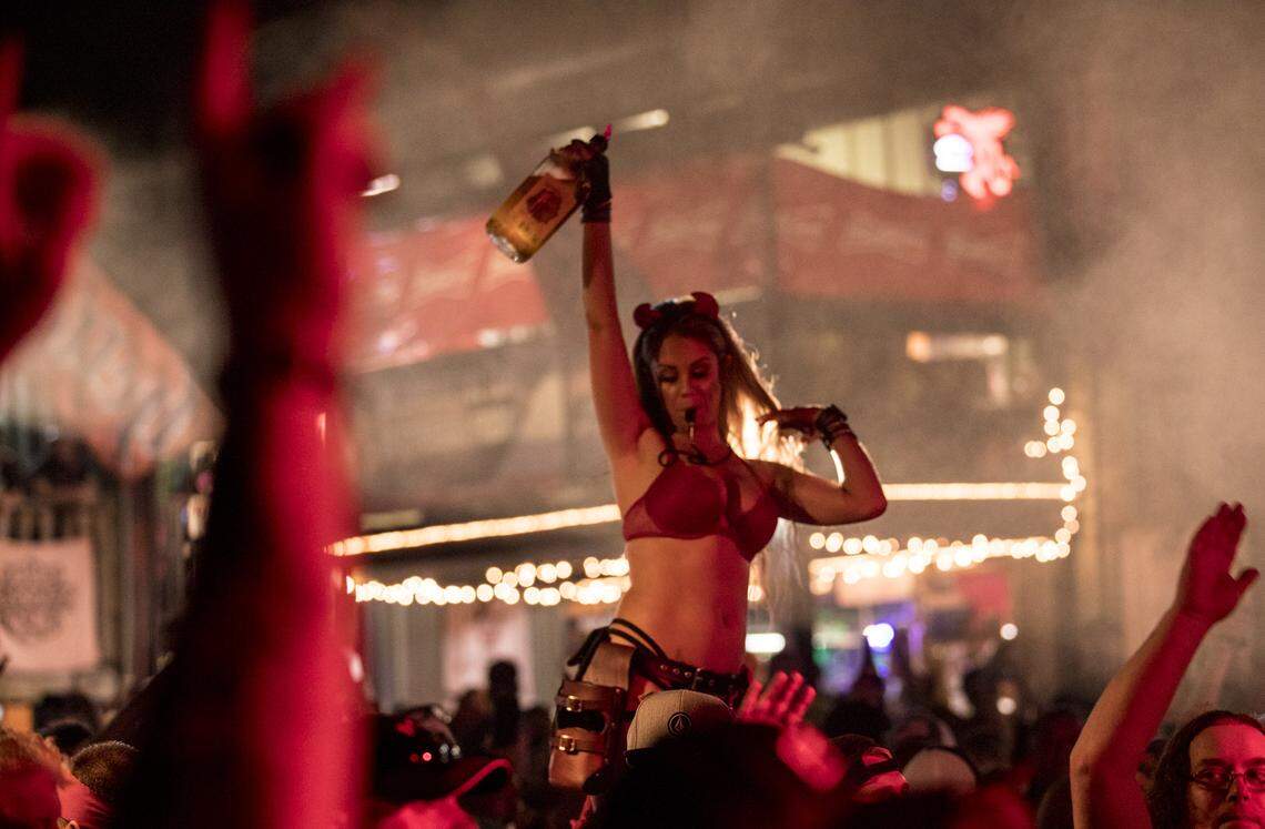 A bartender holding a bottle of Fireball whisky waits on customers as the crowd cheers a band at Suck Bang Blow in Murrells Inlet. Myrtle Beach Bike Week kicked into high gear Murrells Inlet area venues on Friday evening. May 17, 2018.