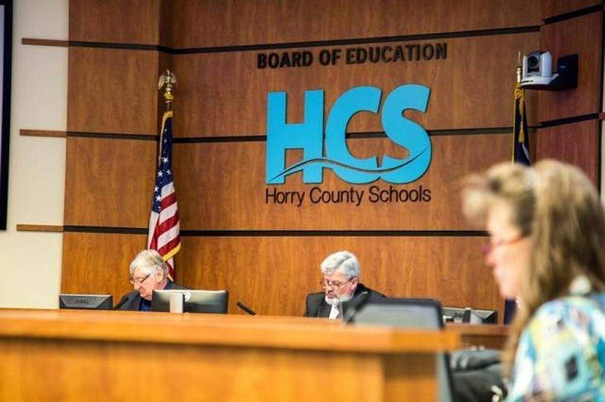 Pictured are Horry County Schools Superintendent Rick Maxey (center) and school board Chairman Joe DeFeo (left).