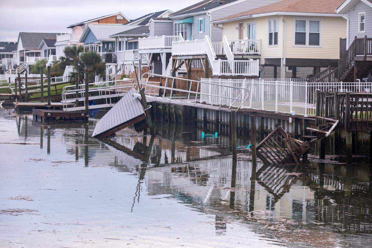 Flooding and storm surge from Hurricane Isaias damaged docks in the Cherry Grove area canals and left a debris field on the beach in North Myrtle Beach after a section of pier collapsed and sand dune walkways were destroyed. August 4, 2020.