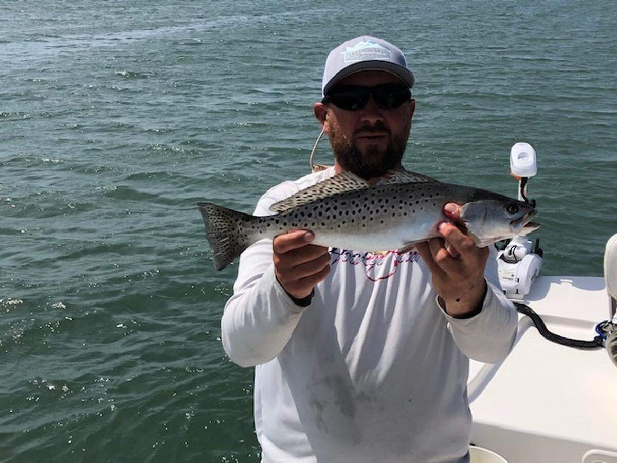 Capt. Dan Connolly of O-Fish-Al Expeditions shows off a spotted seatrout caught Sunday in Murrells Inlet.