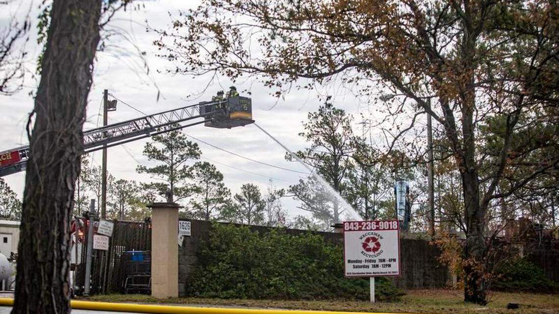 Crews work to extinguish a fire at Waccamaw Recycling off of Stockholder Ave. in Myrtle Beach Monday.