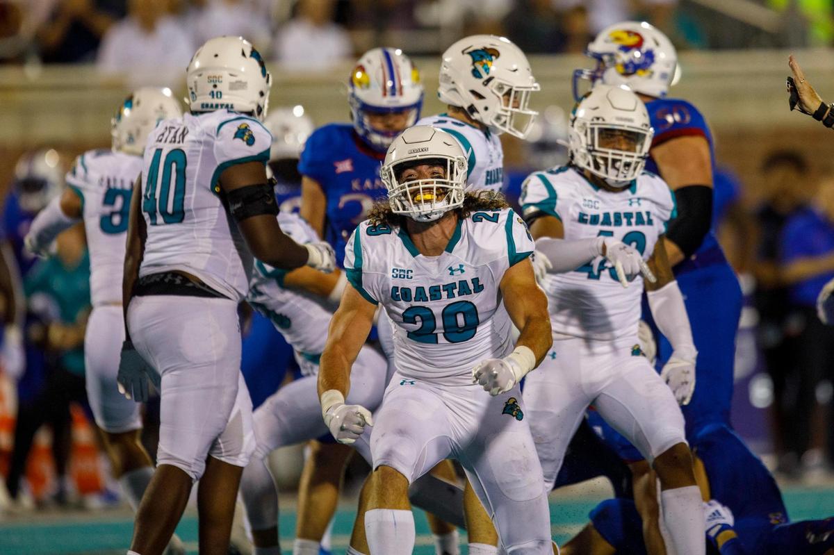 Coastal’s Silas Kelly celebrates a big tackle against Kansas. The Coastal Carolina Chanticleers hosted Kansas at Brooks Stadium on Friday night, Aug. 11, 2021.