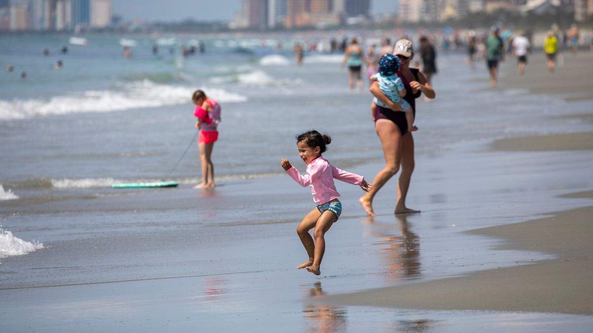 A child jumps the waves in the Arcadian Shores section of Horry County. People online complained of a stinky ocean this week in the Myrtle Beach area.
