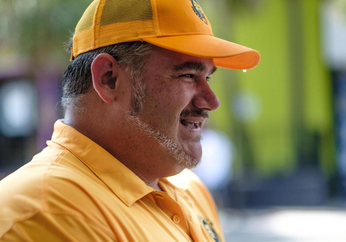 Sweat drips from Jeremy Trendle's gold cap as he takes a break from wiping down trash receptacles along Ocean Boulevard. August 26, 2020.