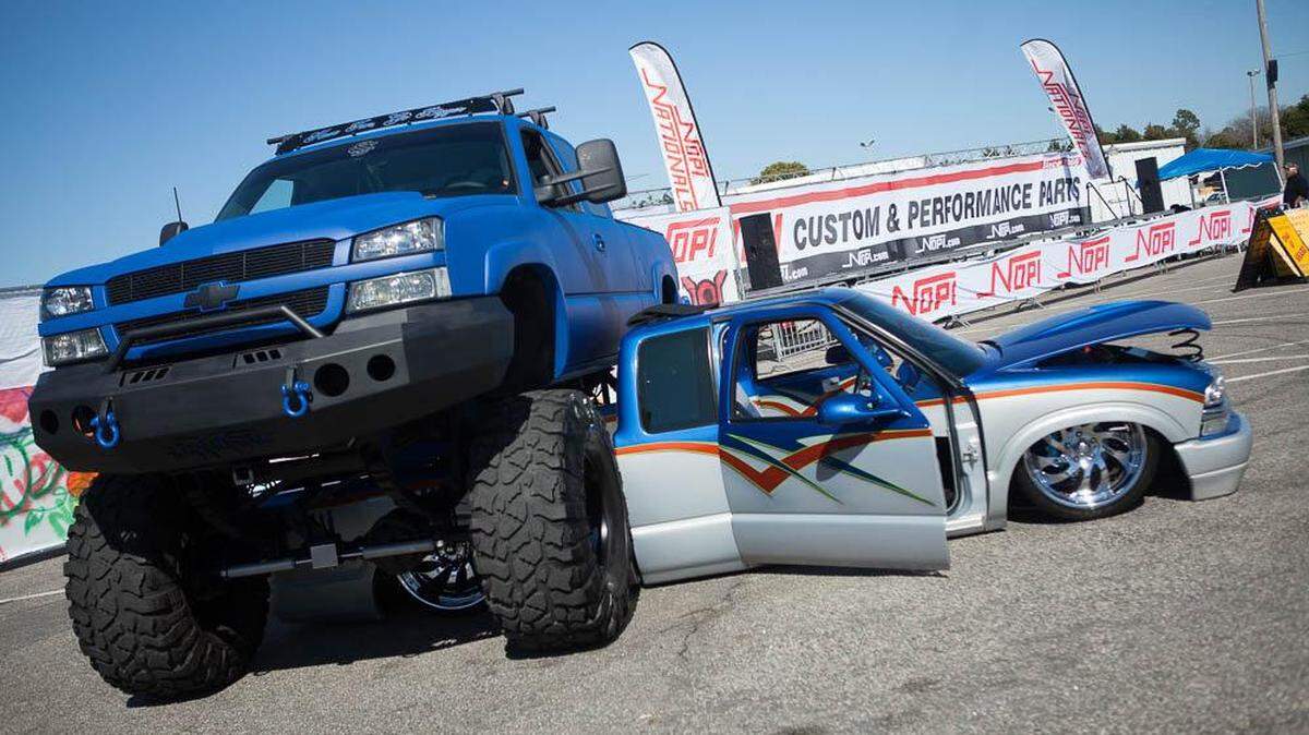 A low rider truck parked under a lifted 4x4 at The NOPI Nationals at Myrtle Beach Speedway in South Carolina. A bill advancing in the N.C. General Assembly would ban angled lifts of certain heights.