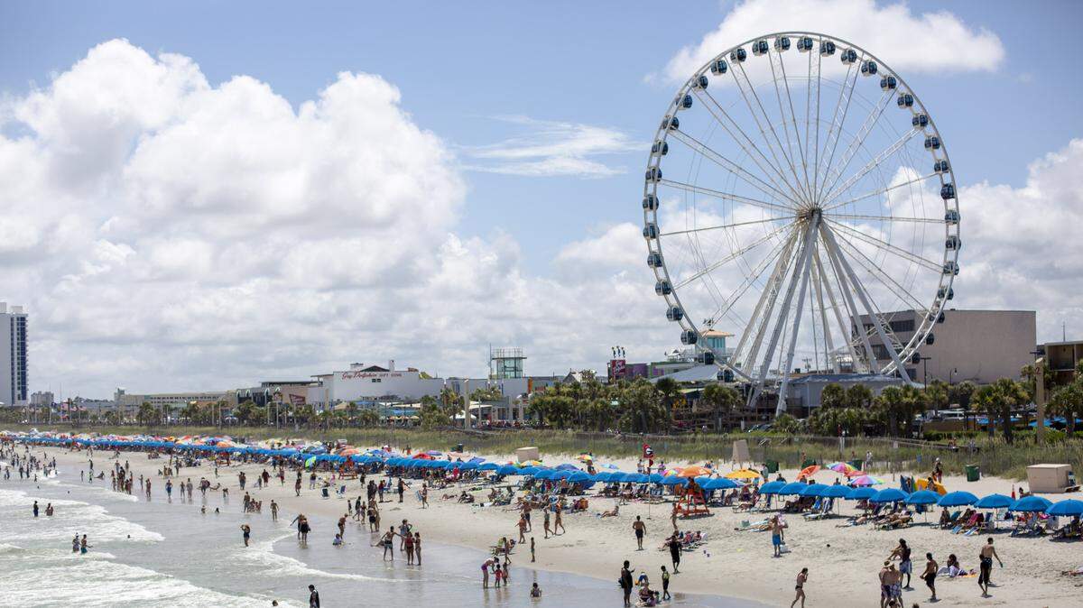 A view of the beach and SkyWheel looking south from Pier 14 in Myrtle Beach on July 4, 2019.
