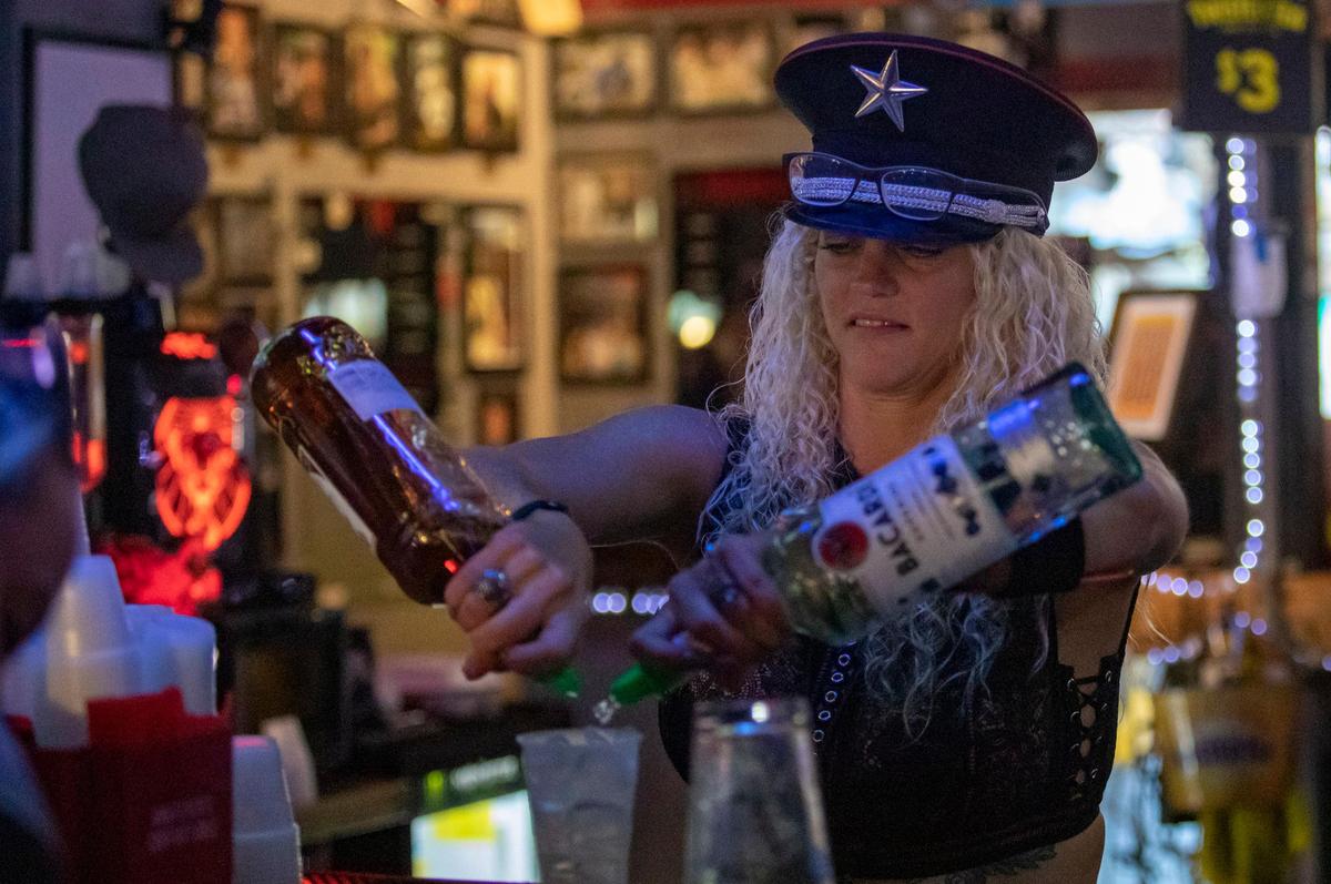 Florida resident Wendy Browning tends bar Friday night at Suck Bang Blow in Murrells Inlet during Bike Week.