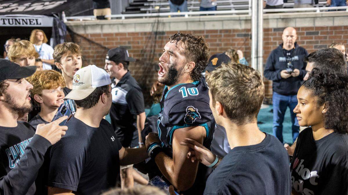 Coastal quarterback Grayson McCall celebrates with students on the field after the win against App State. The Coastal Carolina Chanticleers beat rival Appalachian State 35-28 in front of a record crowd at Brooks Stadium Thursday night. November 3, 2022. McCall spent his career under Jamey Chadwell, who recently departed CCU for Liberty University. Tim Beck was announced as his replacement on Dec. 12.