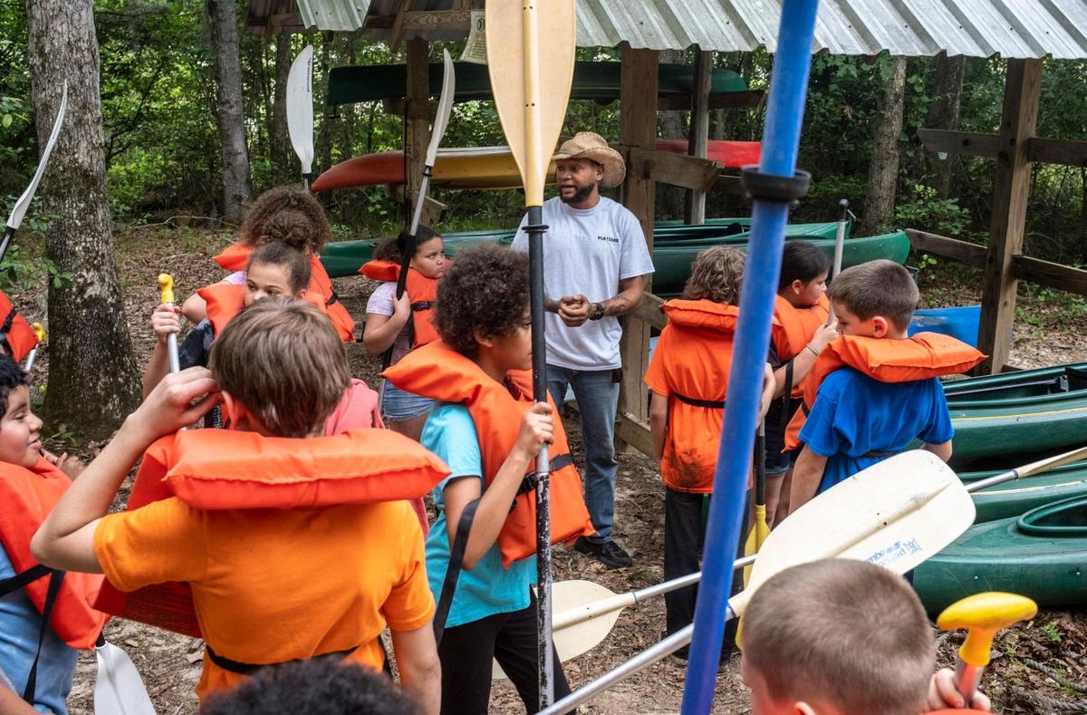 William Steele, an environmental volunteer gives students instruction before taking them kayaking in Playcard Swamp. Fourth grade students from Loris Elementary School take one of the final field trips of the school year to Playcard Environmental and Education Center where they learn about nature, do team building exercises and have fun outdoors. May 24, 2022.