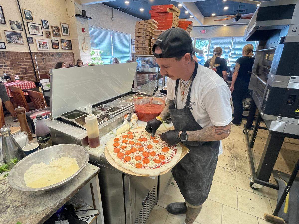 Anto’s Pizza Romana & Italian Market owner Anthony Ludovici DeBrigida prepares a pie Monday, Oct. 14, 2024. The eatery’s had a soft opening this week with the grand opening Friday, Oct. 18, 2024.