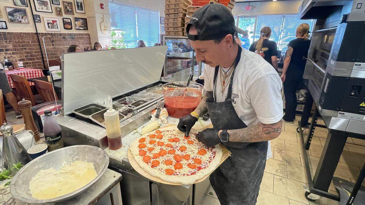 Anto’s Pizza Romana & Italian Market owner Anthony Ludovici DeBrigida prepares a pie Monday, Oct. 14, 2024. The eatery’s had a soft opening this week with the grand opening Friday, Oct. 18, 2024.