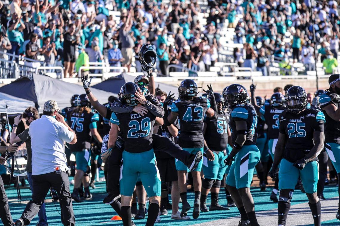 Coastal Carolina players celebrate D’Jordan Strong’s interception return for a score against Appalachian State in the final minutes of the game Saturday. Coastal Carolina played Appalachian State with first place in the Sun Belt Conference’s East Division on the line at Brooks Stadium in Conway. Nov. 21, 2020.