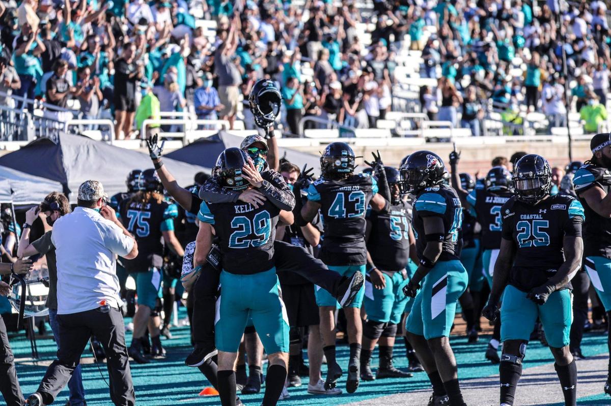 Coastal Carolina players celebrate D’Jordan Strong’s interception return for a score against Appalachian State with 1:20 to play in the game Saturday. Coastal Carolina played Appalachian State with first place in the Sun Belt Conference’s East Division on the line at Brooks Stadium in Conway. Nov. 21, 2020.