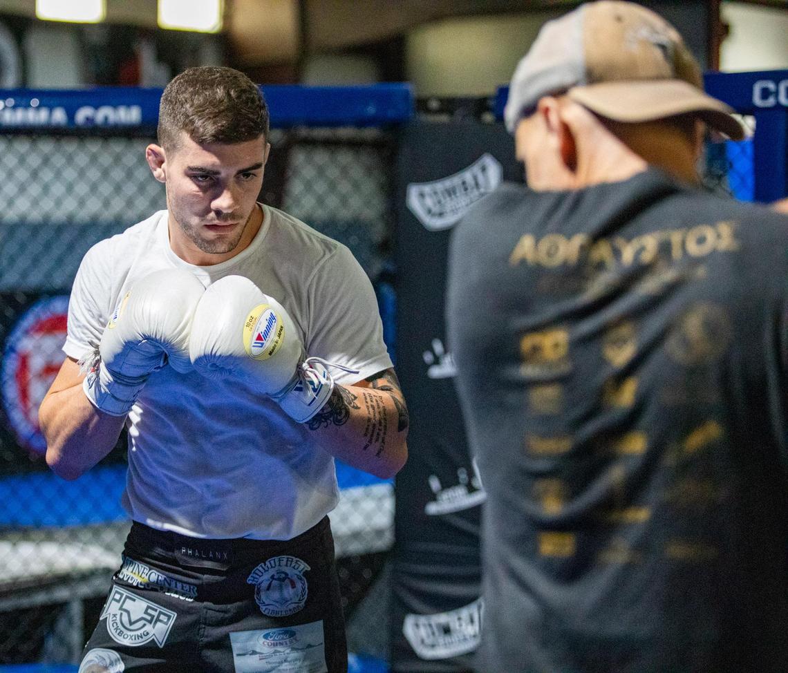 MMA fighter Joe Solecki works with his trainer, Chris Goude, Tuesday afternoon at Fitness Edge in Conway.