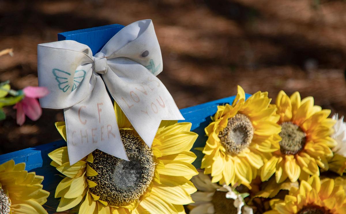 A cheer bow can be seen tacked to a roadside memorial for Rachel Mullen along Carolina Forest Boulevard in Myrtle Beach. Mullen died in a car crash in 2018 on Carolina Forest Boulevard. She was 19 years old.