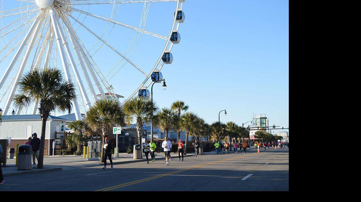 Participants in the Myrtle Beach Marathon run past the SkyWheel on Saturday, Feb. 14, in Myrtle Beach.
