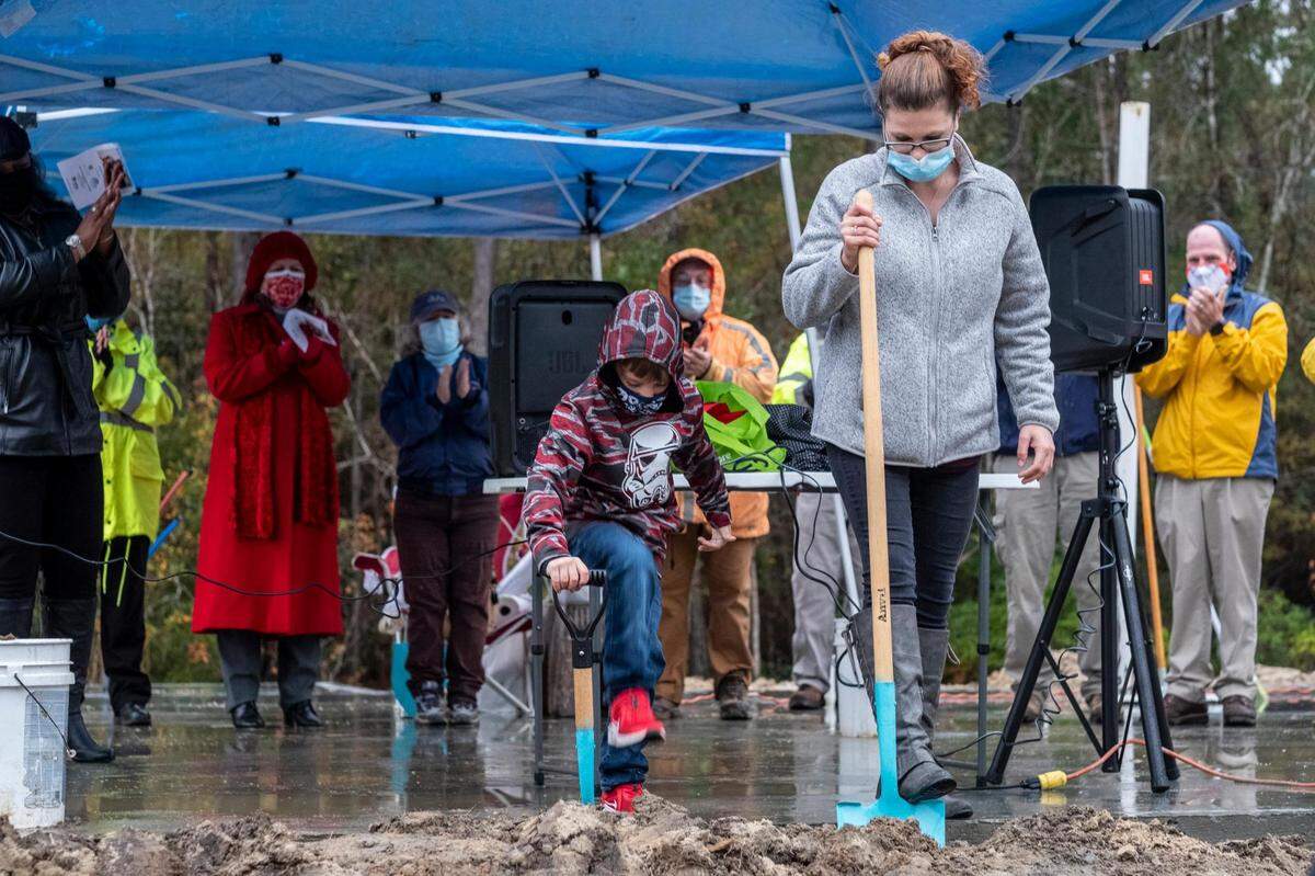 Kimberly Miller and her six-year-old son Tanner Ray attend a ground breaking of their new Habitat for Humanity home near Conway, S.C. December 16, 2020.