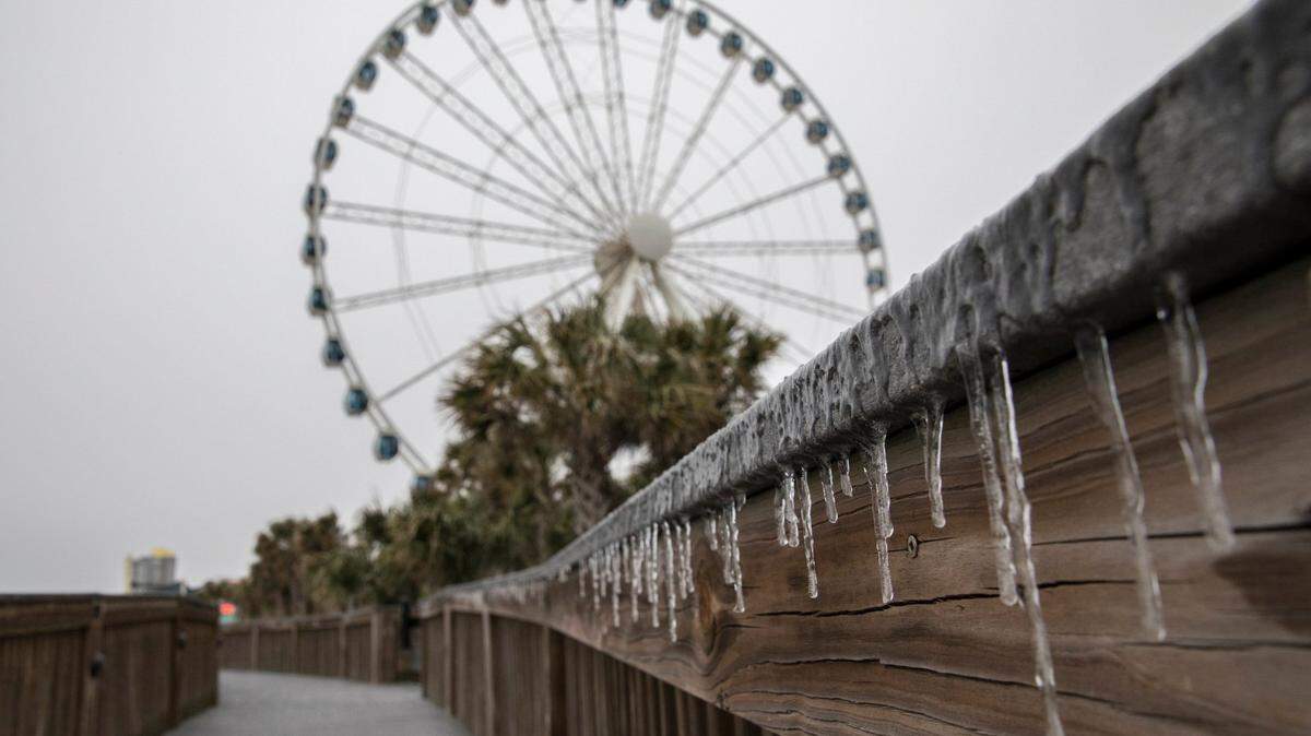 Ice coats the boardwalk in Myrtle Beach. Forecasters expect Winter Storm Grayson to drop up to four inches of snow and ice on the Grand Strand area on Wednesday evening. Jan. 3, 2018.