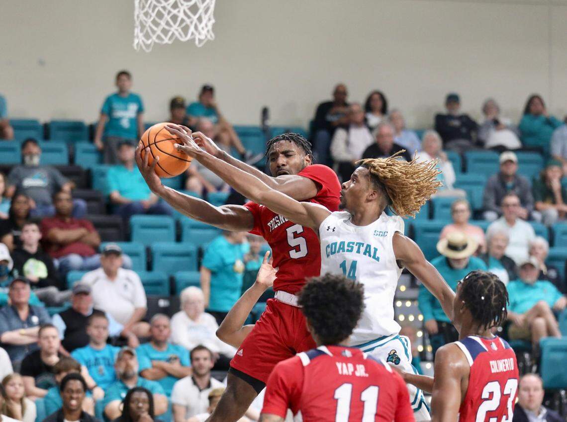Fresno State’s Jordan Campbell (5) is defended by Coastal Carolina’s Josh Uduje (14) during the Chanticleers’ 85-74 loss in The Basketball Classic championship game at the HTC Center in Conway SC on Friday night.