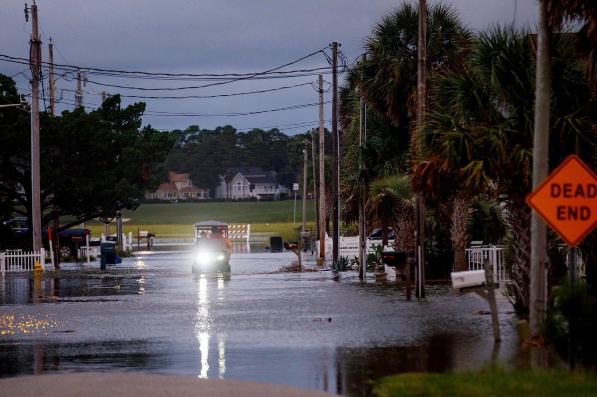 A golf cart drives through tidal flooding in the Cherry Grove section of North Myrtle Beach on Monday evening. King tides are causing flooding in Cherry Grove this week. The South Carolina Department of Health and Environmental Control predicted six weeks of above average tides this year which cause cause significant flooding especially went combined with high on-shore winds. Sept. 16, 2024.