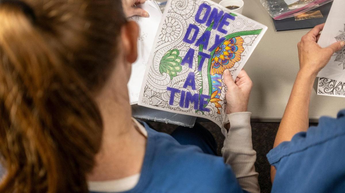 A student at J. Rueben Long Detention Center near Conway, S.C holds up a piece of her art work during a an addiction recovery class. With new classes at J.Reuben Long Detention Center, female detainees are able to take part in “Next Step” addition recovery classes as part of the jail’s pretrial intervention program. July 5, 2023.
