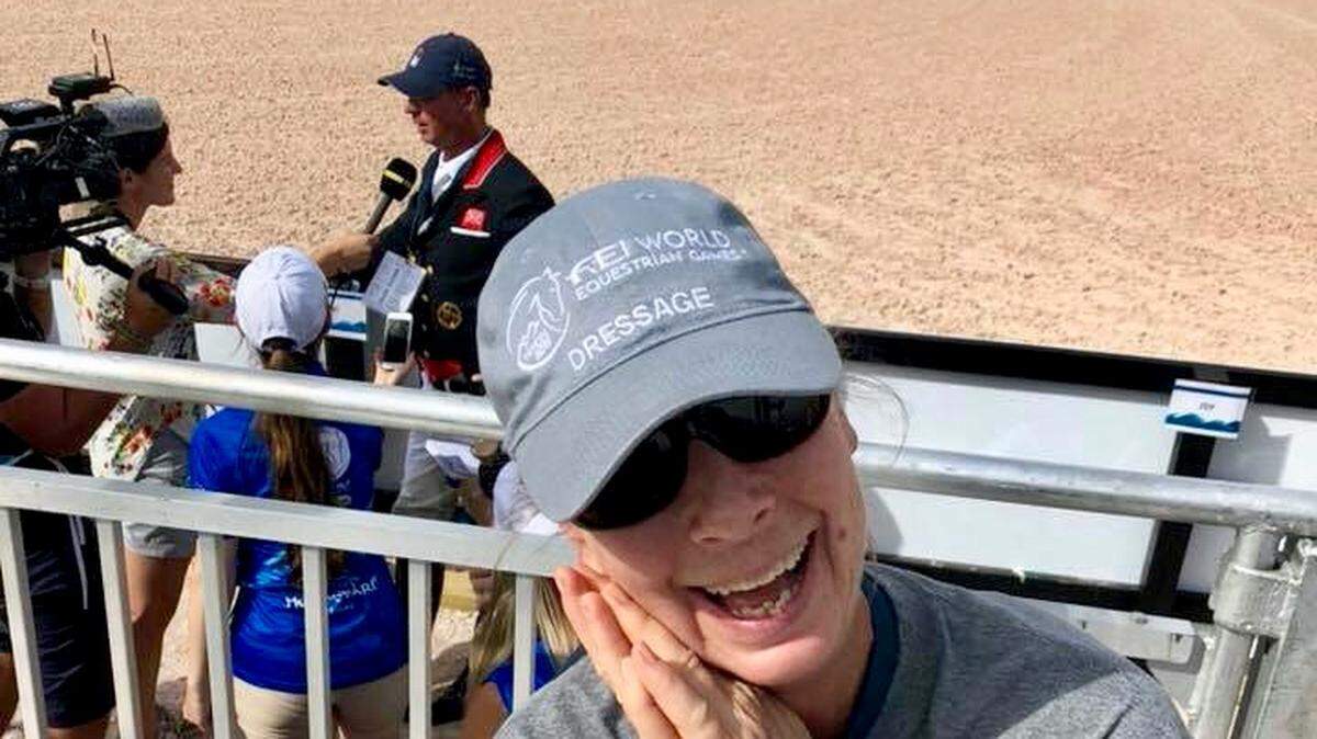 A picture of Pam Stone, with Carl Hester in the background.