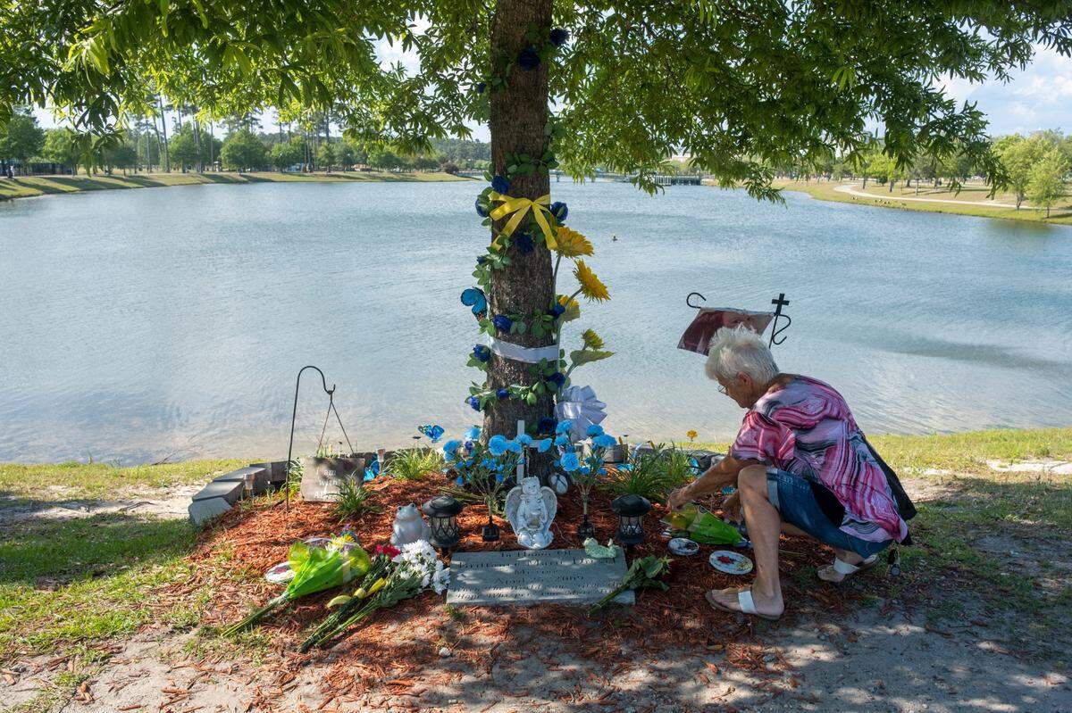 Becky Beckstead places flowers on a memorial at Grand Lake in Market Common for Brittanee Drexel on Monday after Georgetown authorities announced that Drexel’s remains were found and a Georgetown man was charged with her murder. Beckstead said that she and her granddaughter cried together when they heard the news today and the two frequently stopped and prayed for the missing girl during their walks around the lake. May 16, 2022.