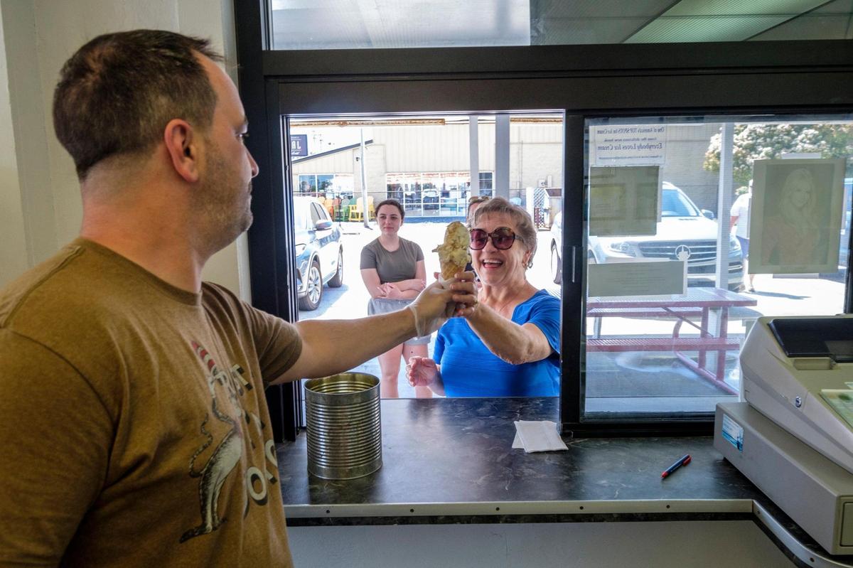 Dominic Munafo serves scoops of ice cream at The Original Painter’s Ice Cream in North Myrtle Beach which opened in 1952. April 22, 2022.